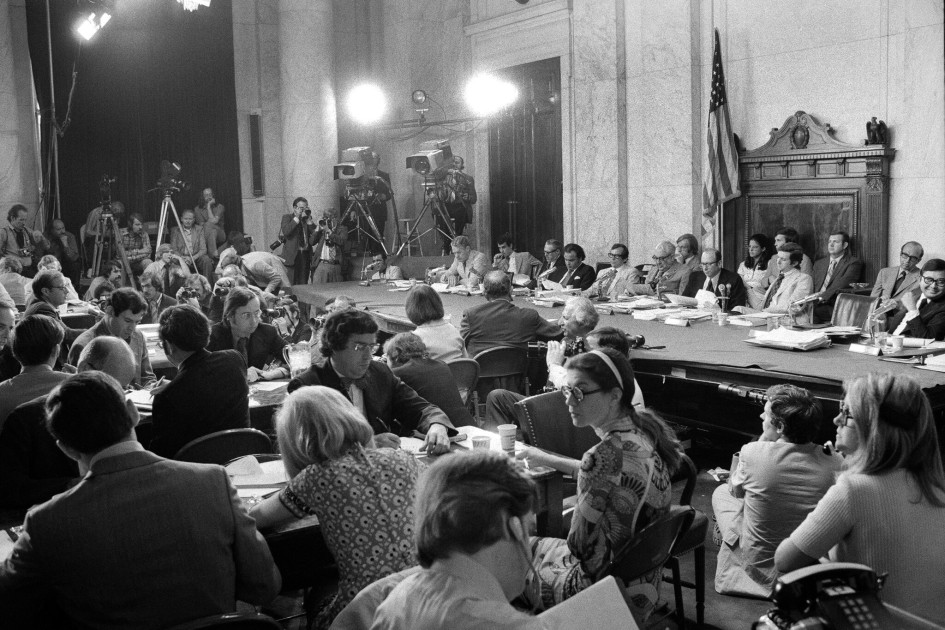 1970s Senate Watergate hearing room with witness microphone