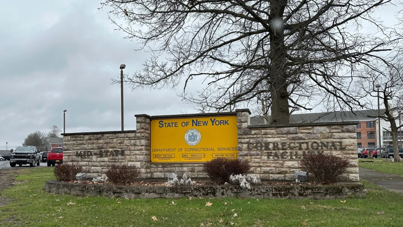 A New York State Department of Corrections and Community Supervision sign at a facility entrance