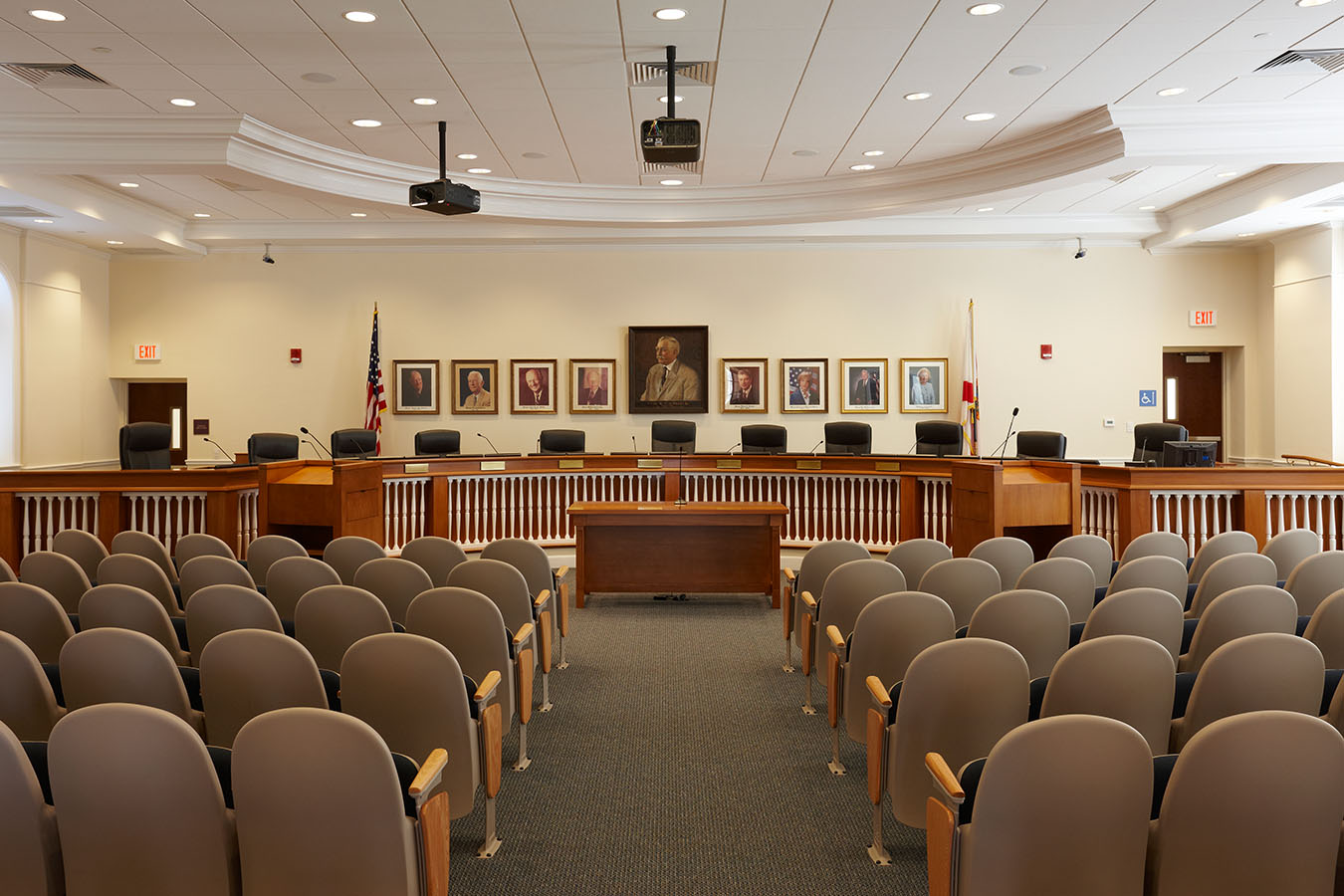 A Palm Beach local government meeting room with dais seating and microphones, photographed when the room is empty