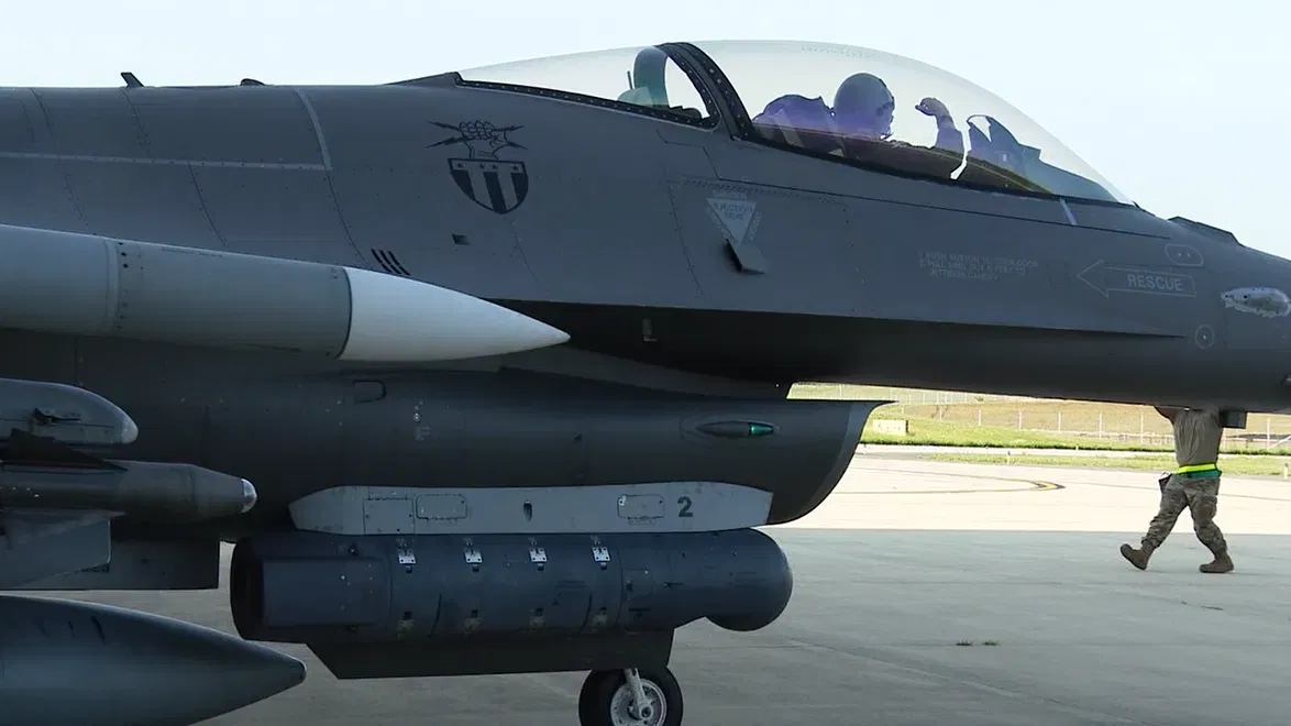 A U.S. Air National Guard F-16 on an air-defense alert ramp, photographed on the ground near maintenance and support equipment