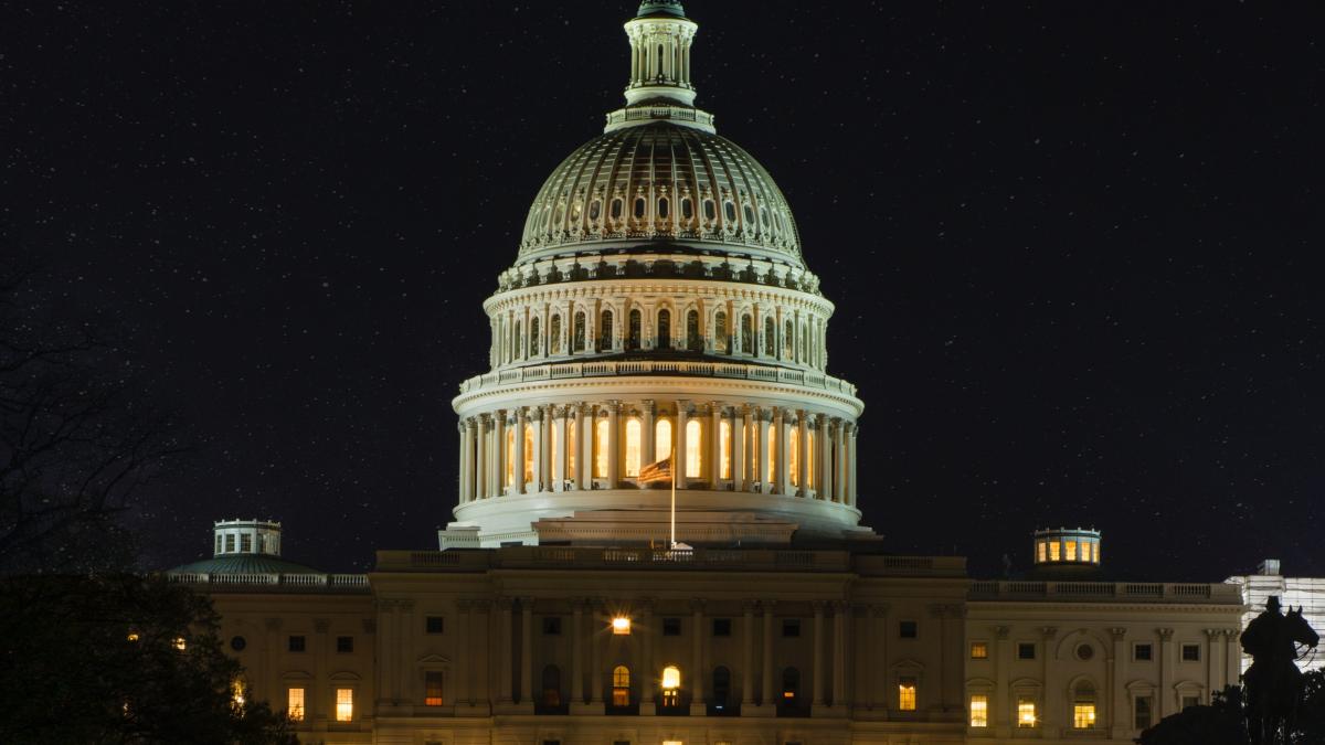 A U.S. Capitol hearing room in Washington, D.C., during a congressional oversight hearing with lawmakers seated at the dais and a witness table in the foreground, news photography style