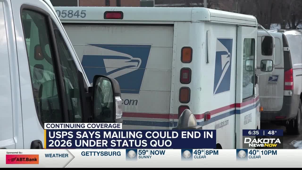 A USPS delivery truck parked curbside on a residential street while a postal worker carries packages, realistic news photography style
