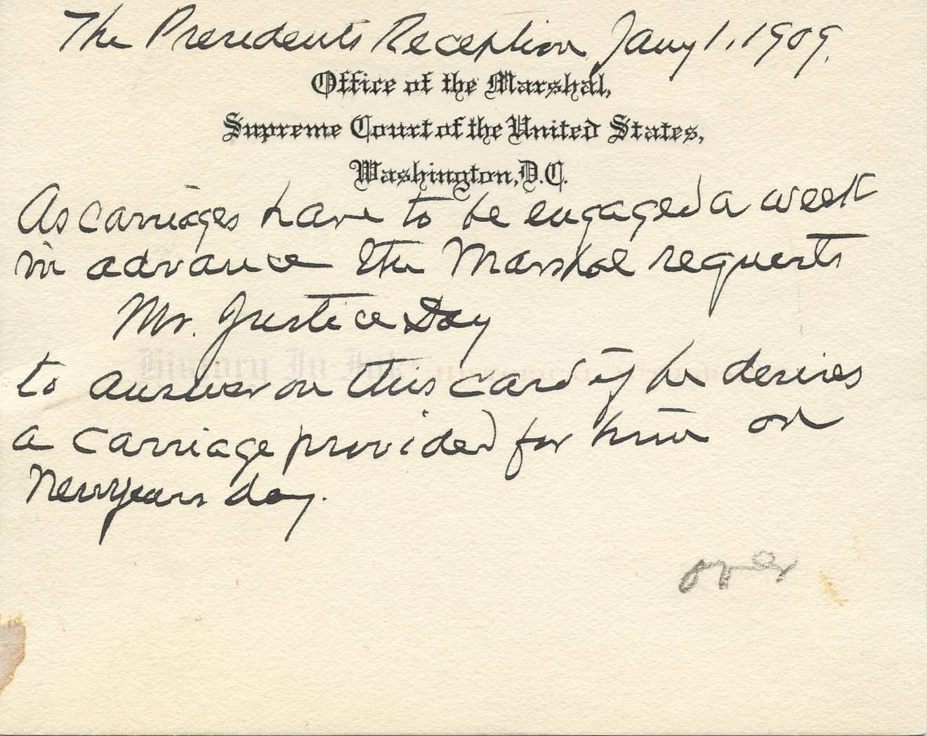 A candid photo of a judge's hands holding a pen over a notebook with legal papers nearby on a polished desk