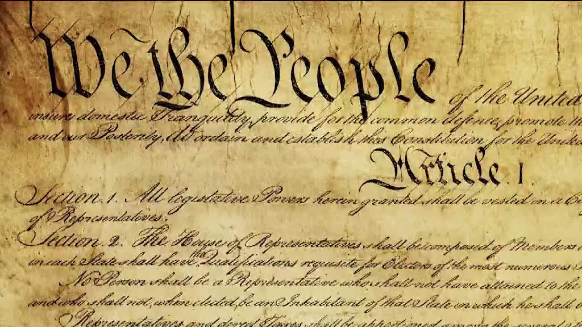 A close, readable photograph of the U.S. Constitution text in Article II, showing the impeachment clause in a printed or archival display