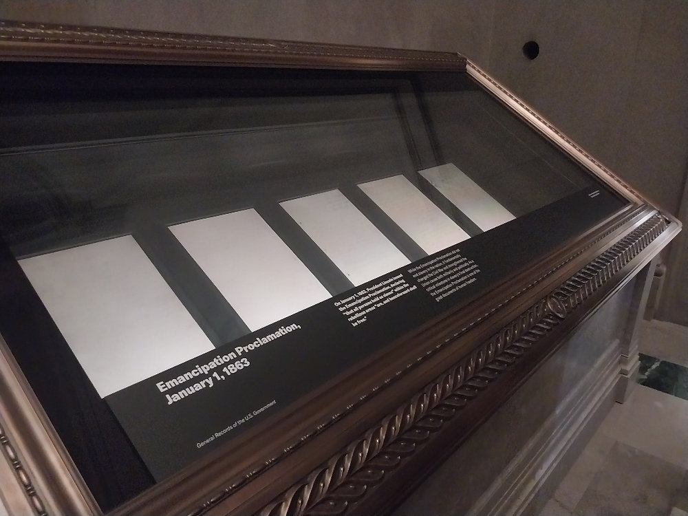 A close view of the Emancipation Proclamation document on display behind protective glass at the U.S. National Archives