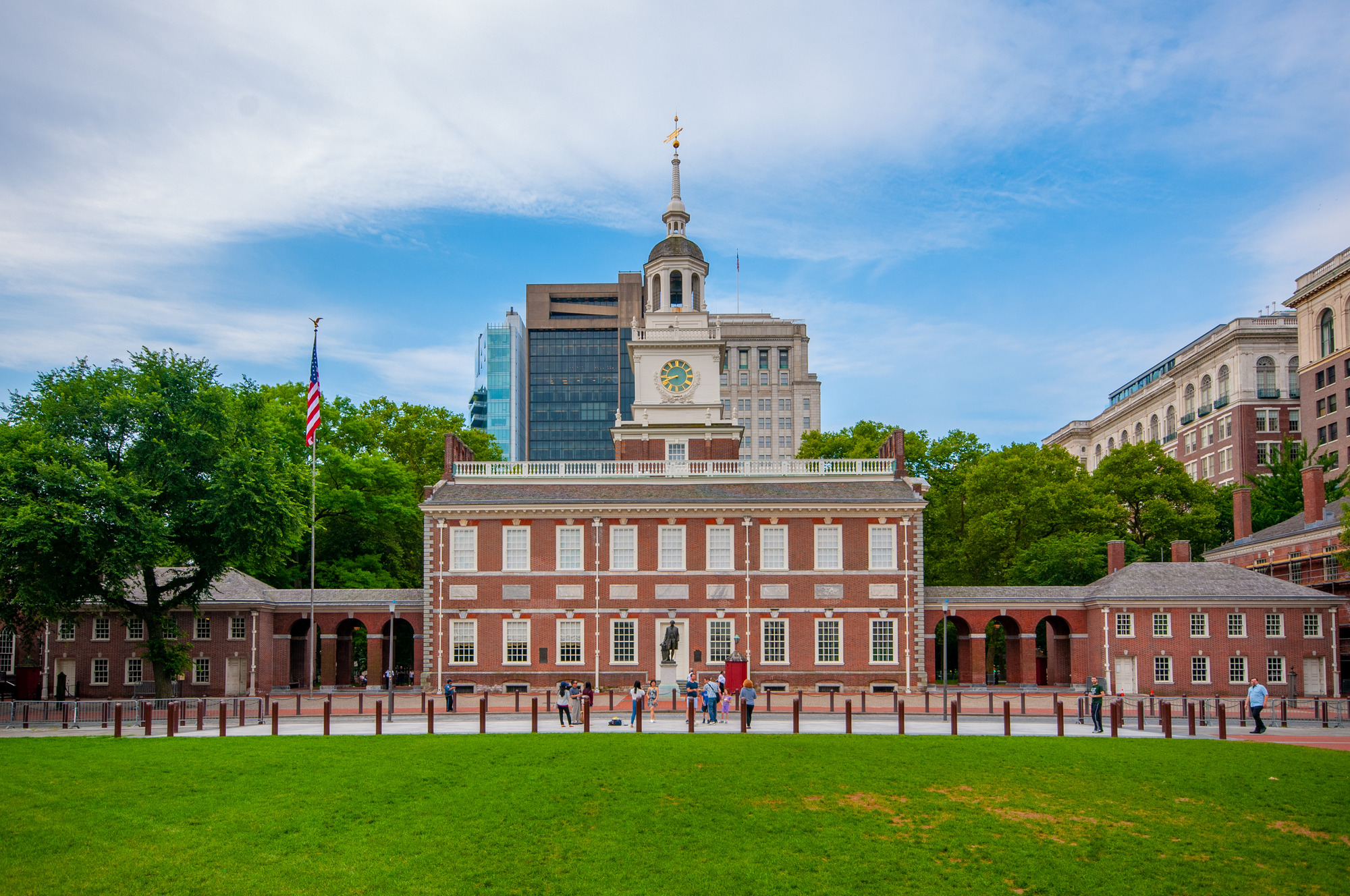 A daytime photograph of Independence Hall in Philadelphia, showing the brick facade and clock tower