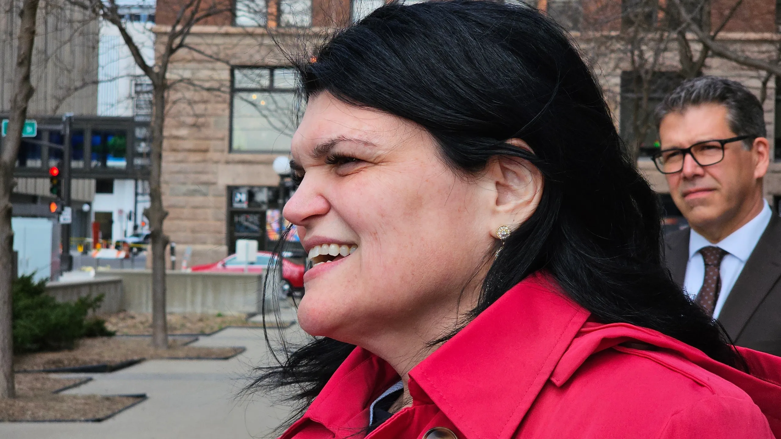 A federal courtroom interior during an immigration-related hearing, with a judge’s bench in the background and attorneys seated at counsel tables, news photography style