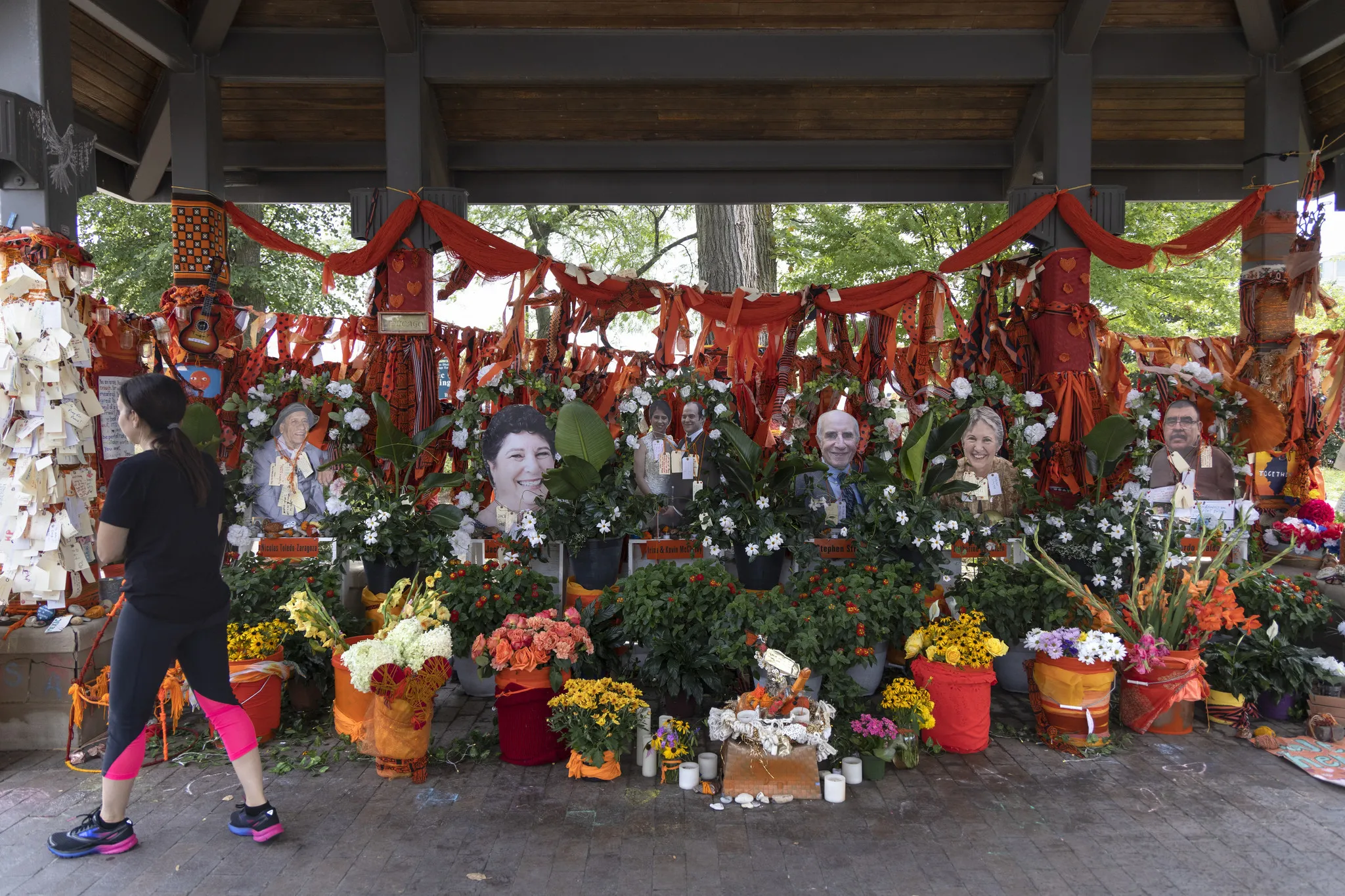 A memorial display in Highland Park, Illinois, with flowers and signs honoring victims of the July 4 parade shooting