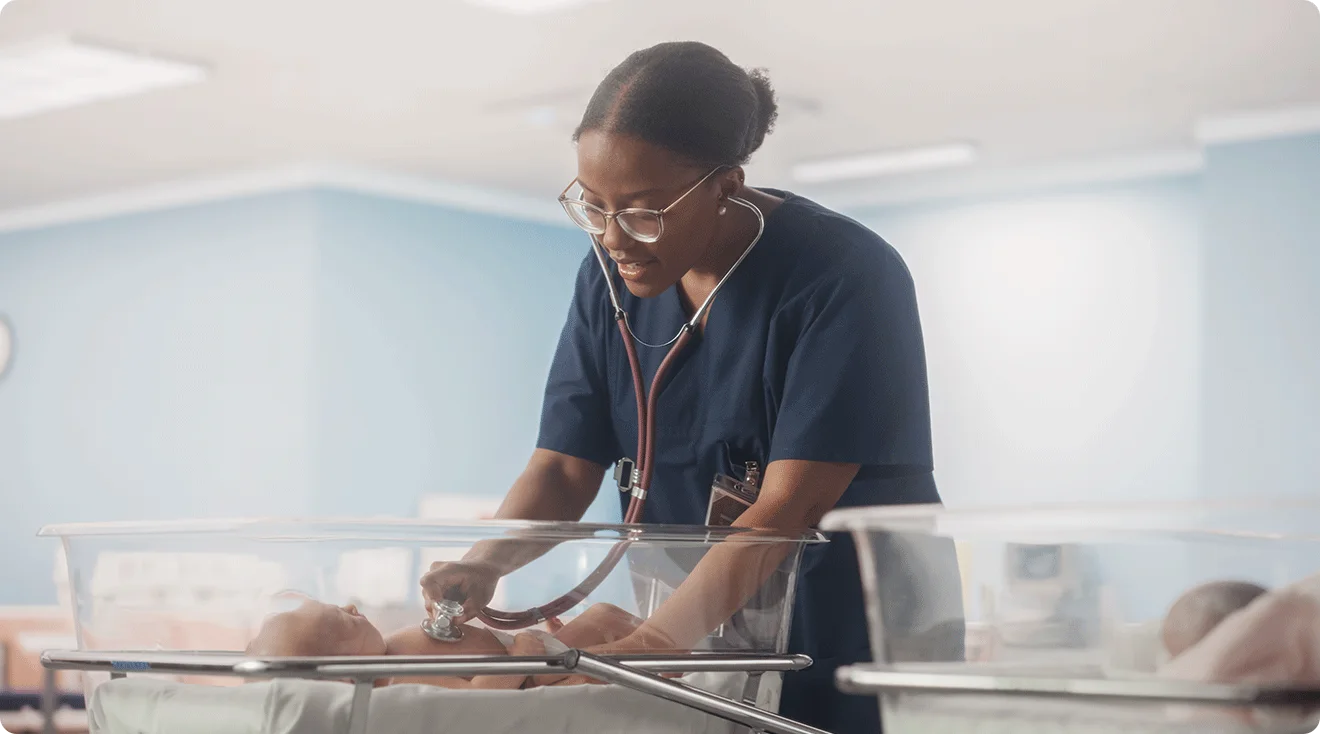 A newborn sleeping in a hospital bassinet in a U.S. maternity ward, natural light, documentary news photography style