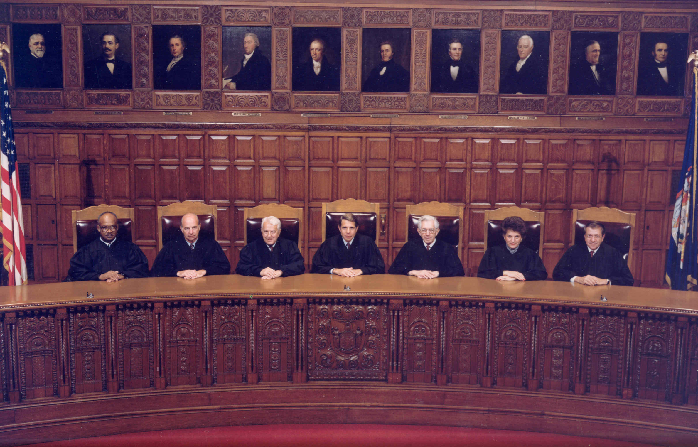 A panel of appellate judges seated behind an elevated wooden bench in a federal appeals courtroom, formal setting, news photography style