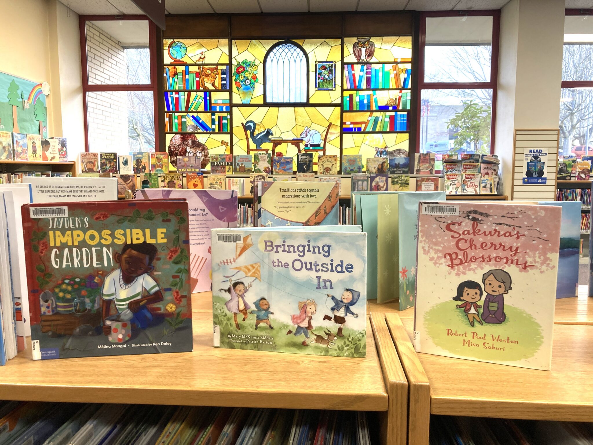 A patron seated at a public library computer terminal viewing a long legal text document on screen, with bookshelves in the background, news photography style