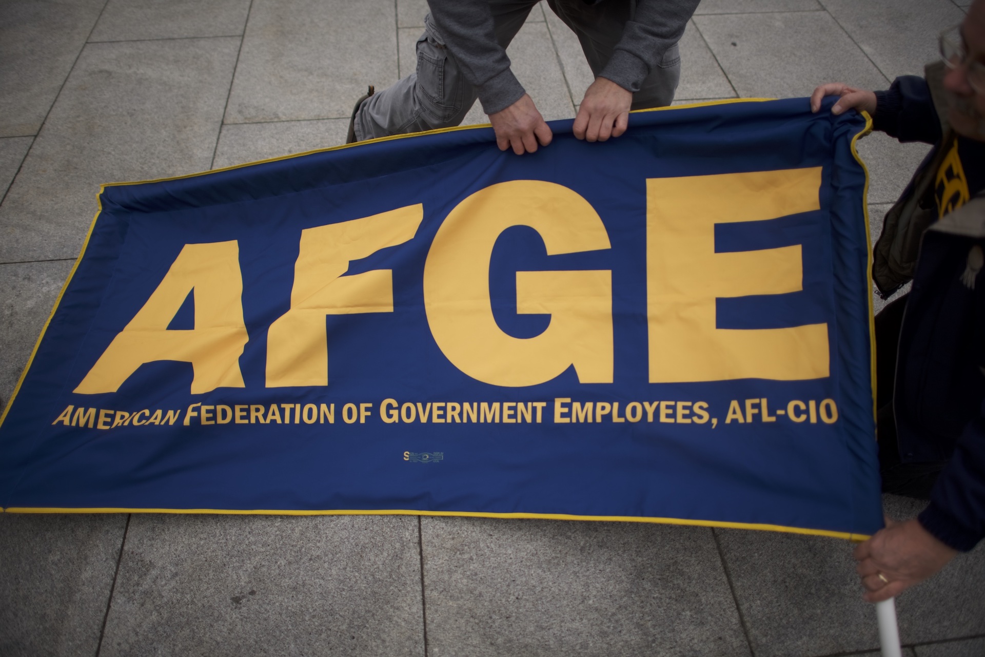 A photograph of American Federation of Government Employees members or signage tied to AFGE TSA Council 100