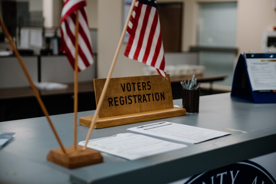 A photograph of a public-facing entrance or office signage associated with the New Jersey Division of Elections