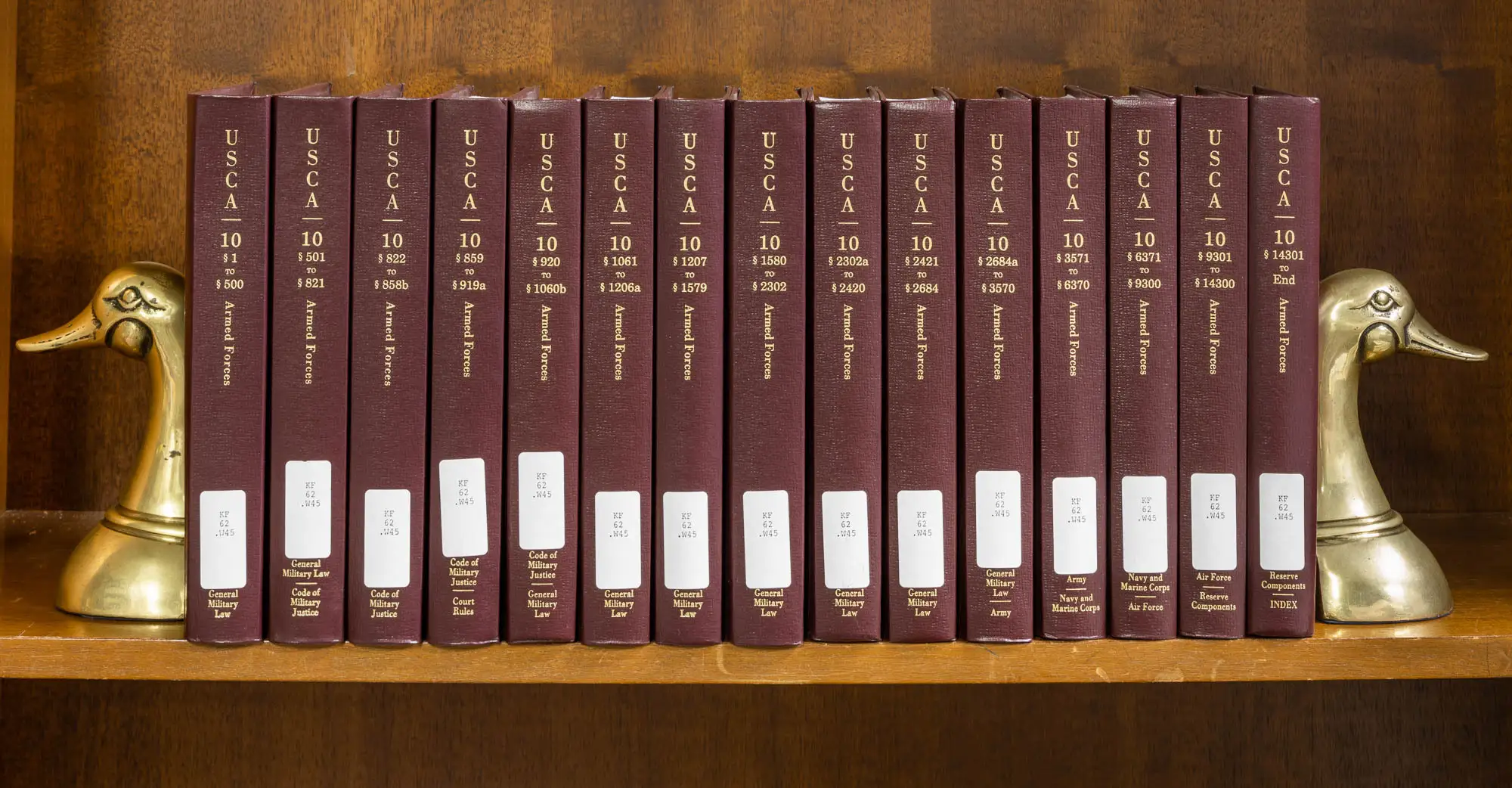A photograph of printed United States Code materials or an official legal reference showing Title 10 provisions associated with the Insurrection Act