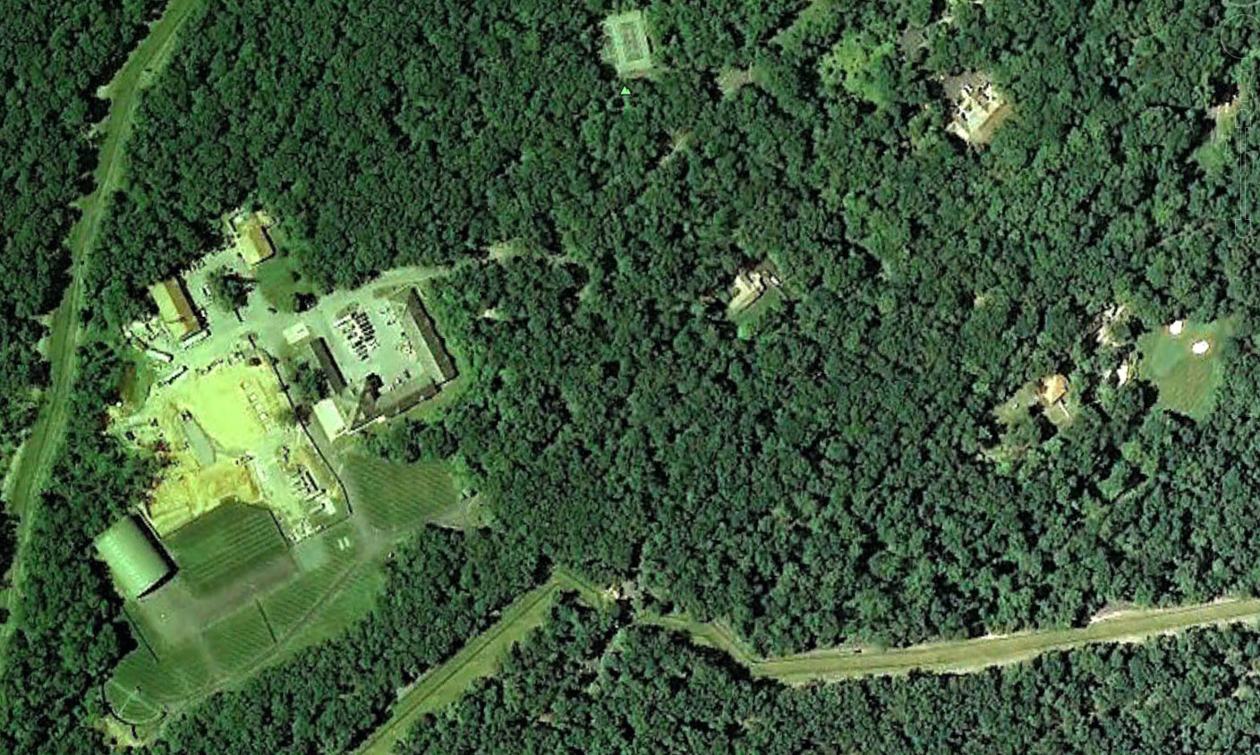 A photograph of the Camp David area in Maryland, surrounded by forested terrain in the Catoctin Mountains