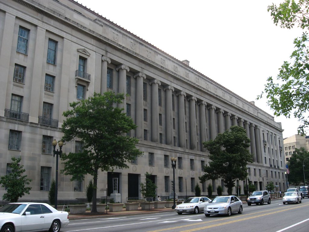 A photograph of the U.S. Department of Justice building in Washington, D.C., showing the main facade and entrance