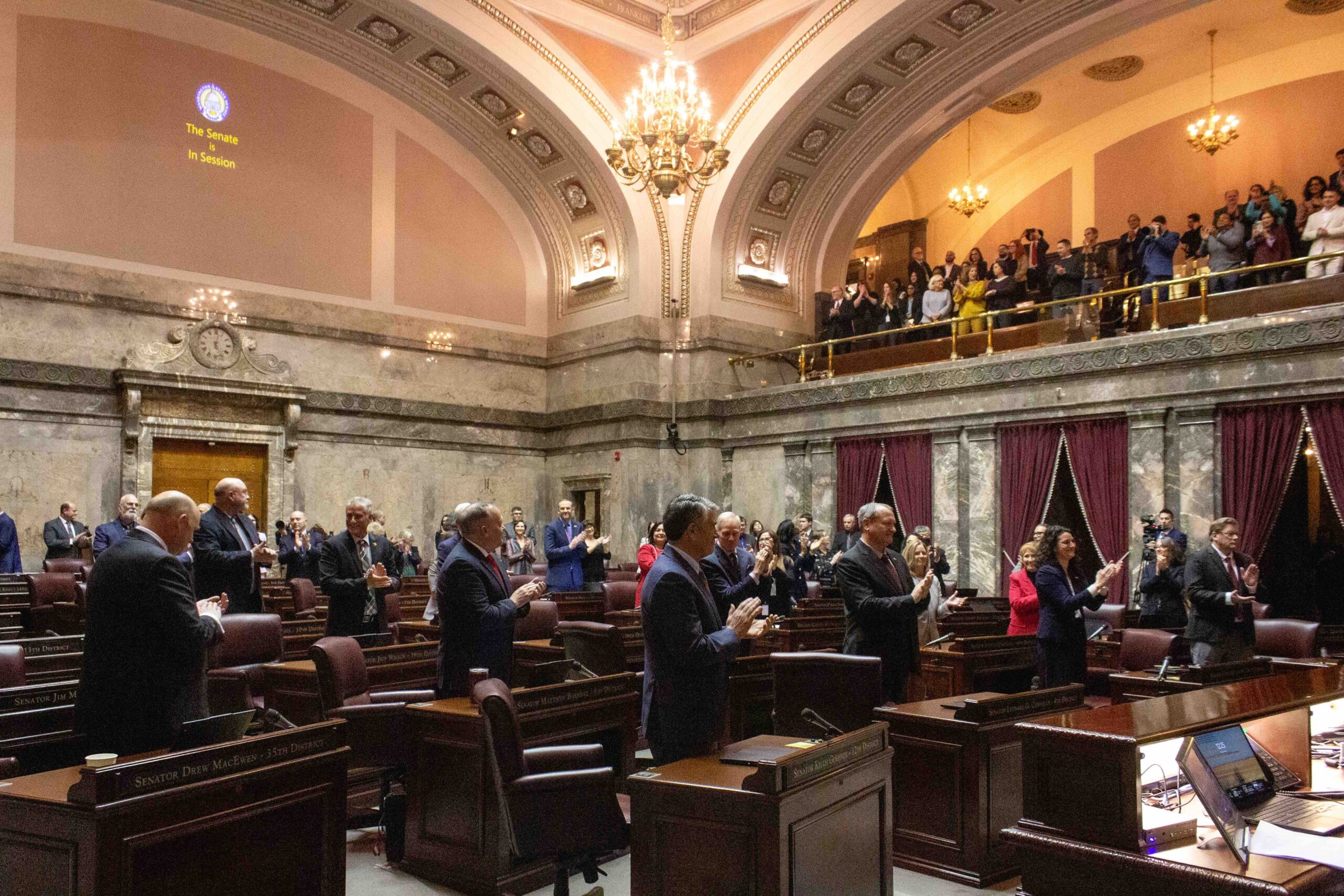 A photograph of the United States Senate chamber during a session, with senators seated at their desks and the presiding officer visible