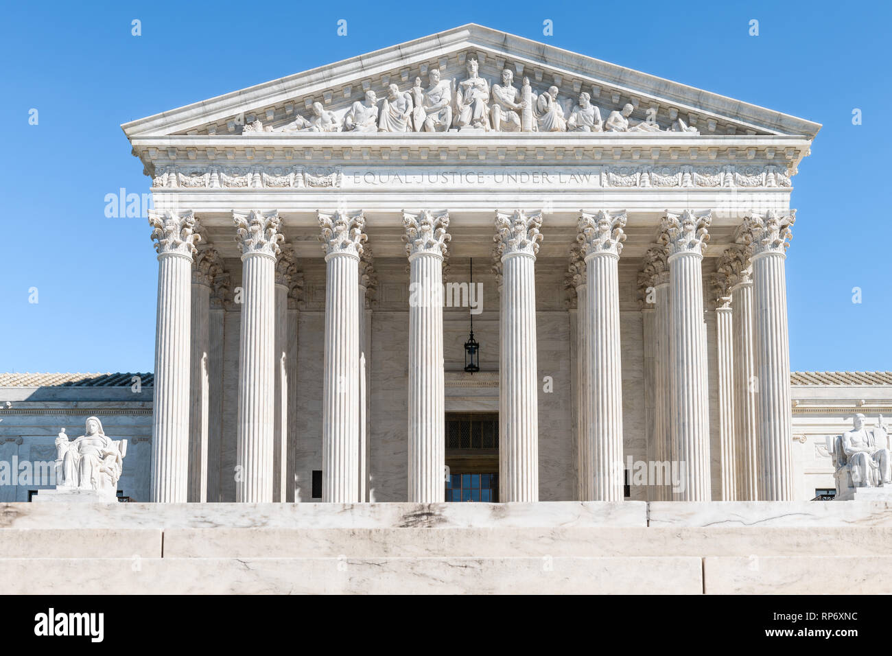 A photograph of the United States Supreme Court building in Washington, DC, seen from the front steps on a clear day with pedestrians in the distance