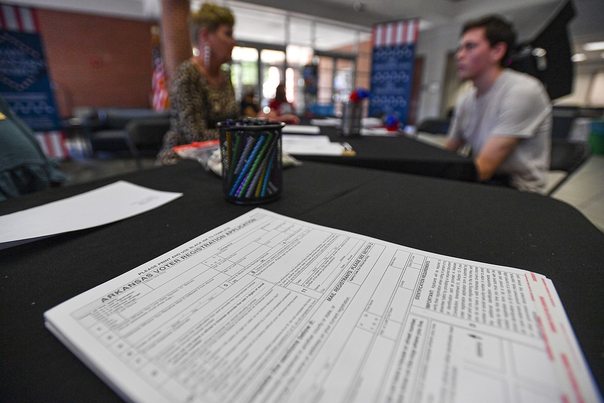 A printed voter registration form on a desk, representing the documents used to certify eligibility