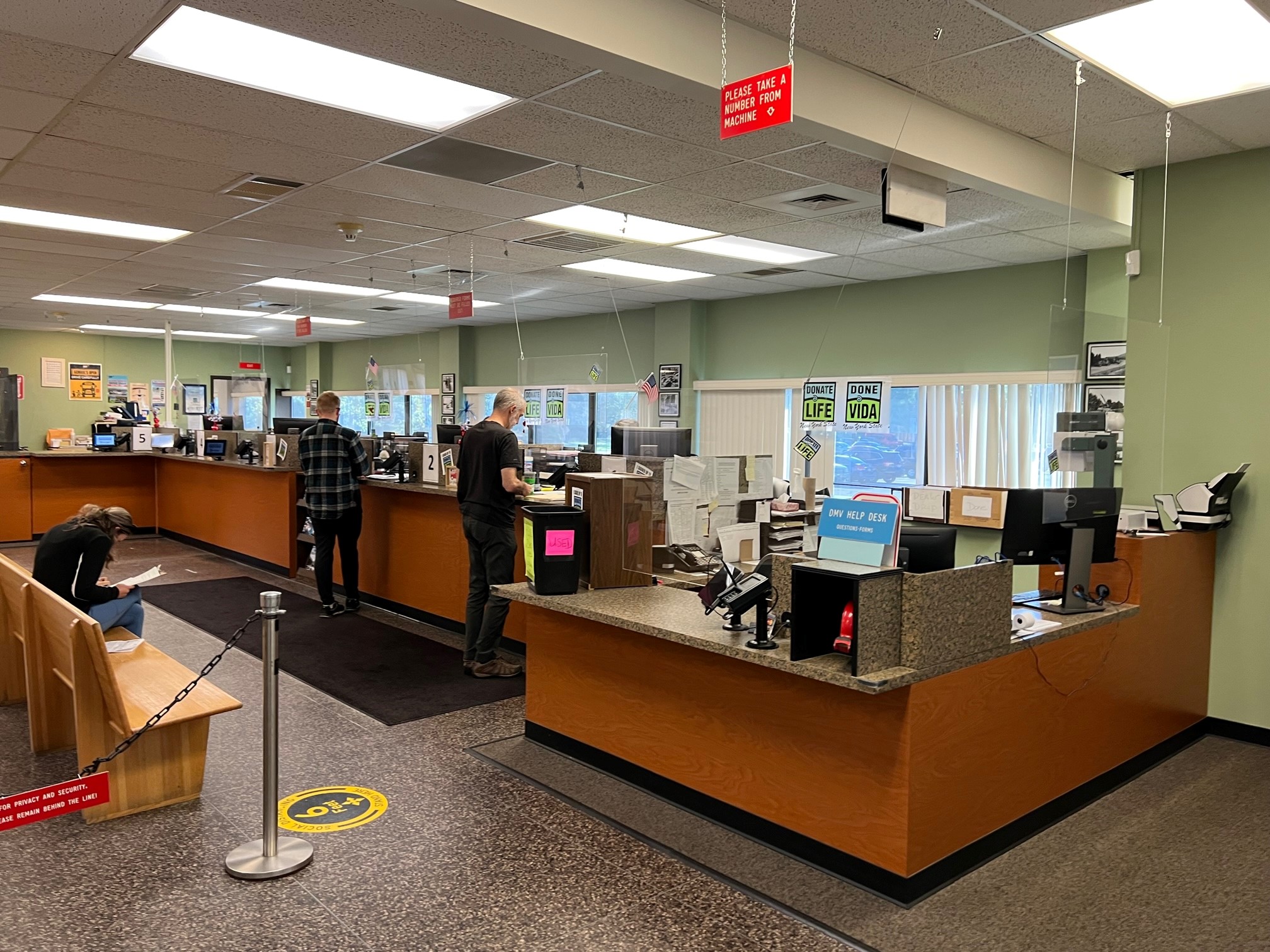 A public service counter inside a state Department of Motor Vehicles office, illustrating how voter registration is often offered during DMV transactions