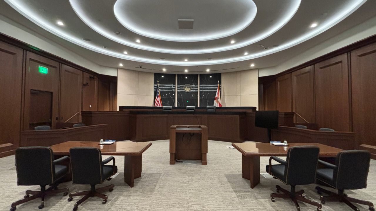A real federal court of appeals courtroom with the judges' bench and counsel tables in view, quiet and empty before a hearing, news photography style
