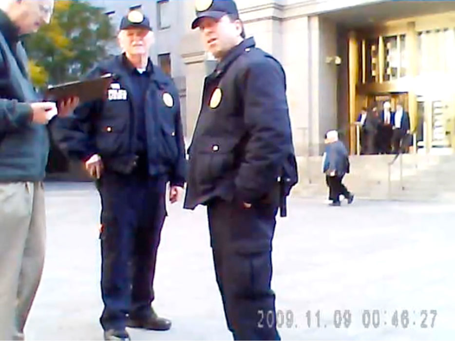 A real news style photograph of heightened security outside a federal courthouse in Washington, D.C. in the early 2000s, with barricades and officers in the foreground