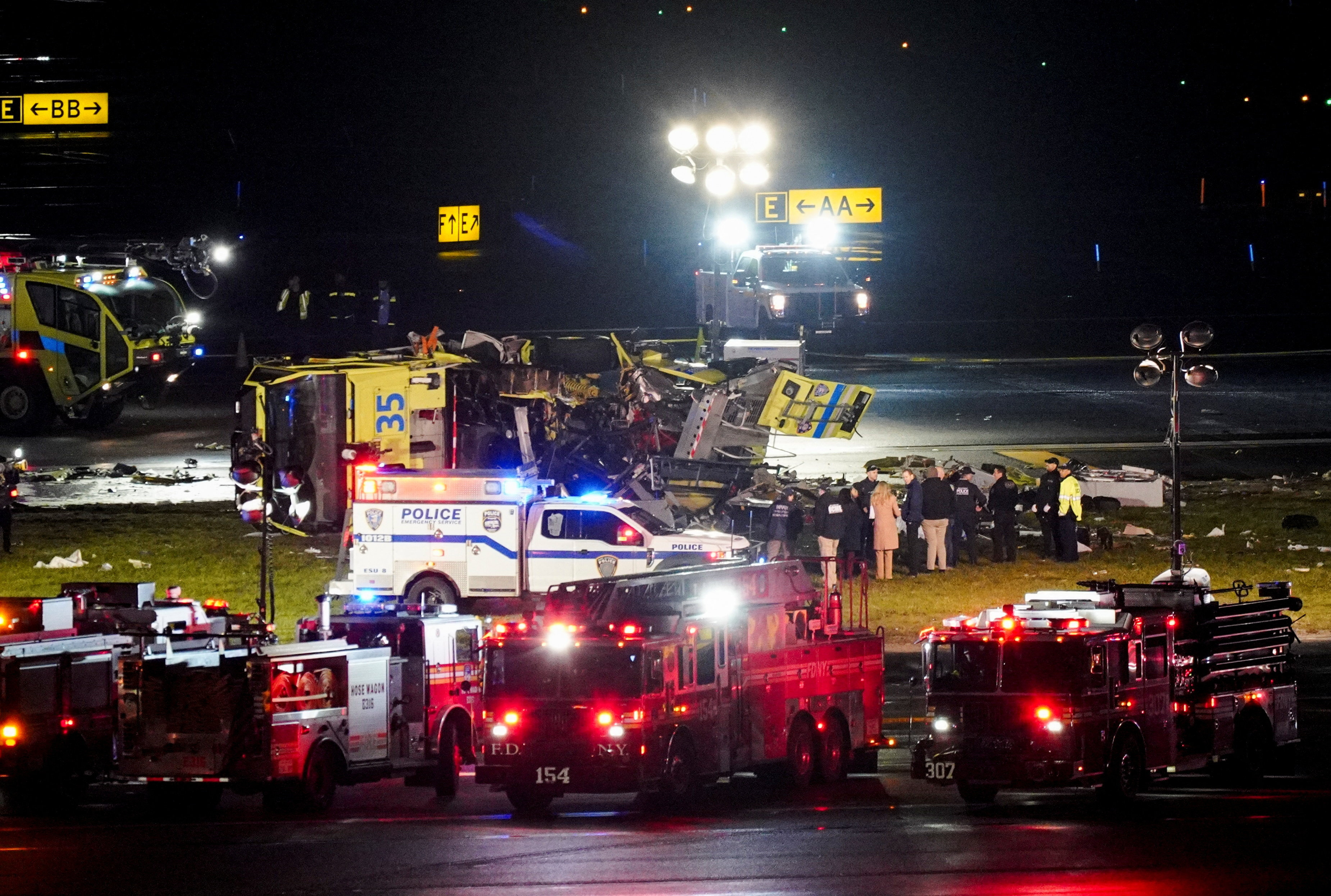 A real photo of a government-marked vehicle stopped at the scene of a minor traffic collision on a city street with police documenting the accident, news photography style