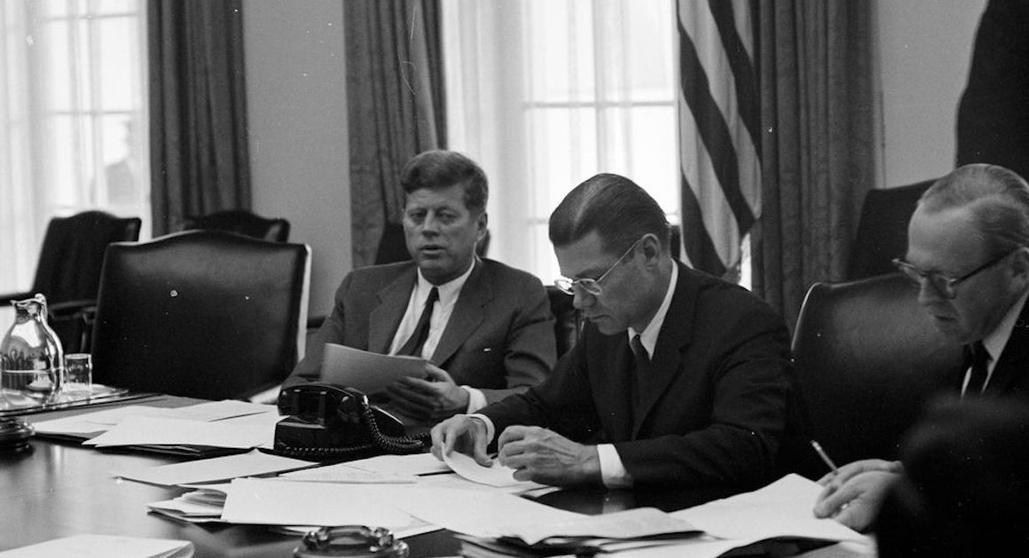 A real photograph of a White House Situation Room or comparable national security meeting with senior officials