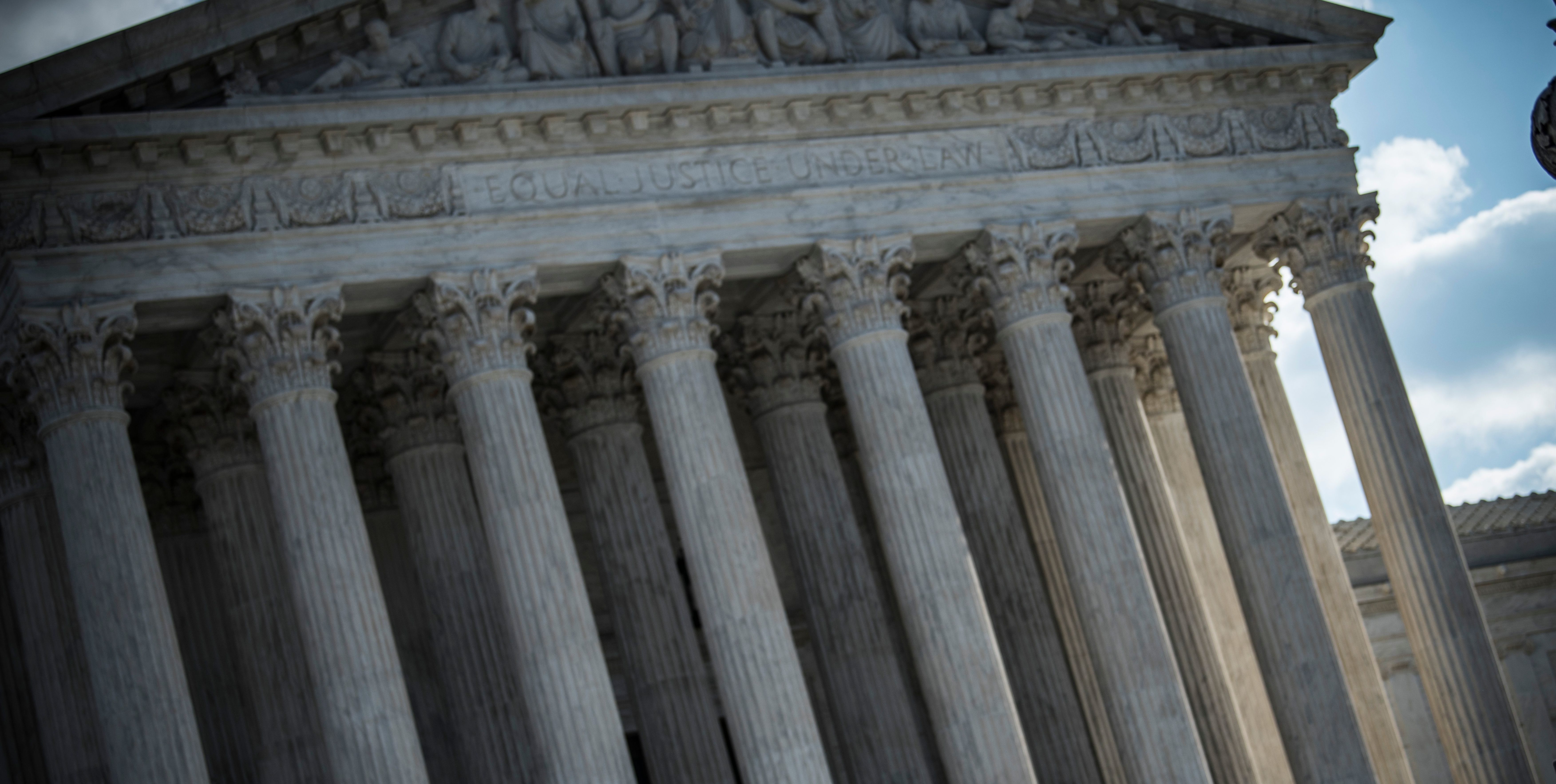 A real photograph of a federal courthouse exterior in New York City, with pedestrians and street activity in front of the building