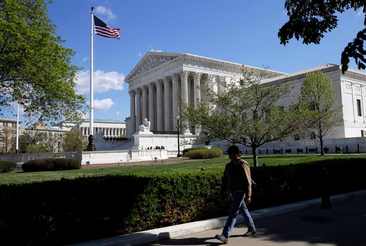 A real photograph of the United States Supreme Court building steps and columns in Washington, DC with pedestrians walking nearby