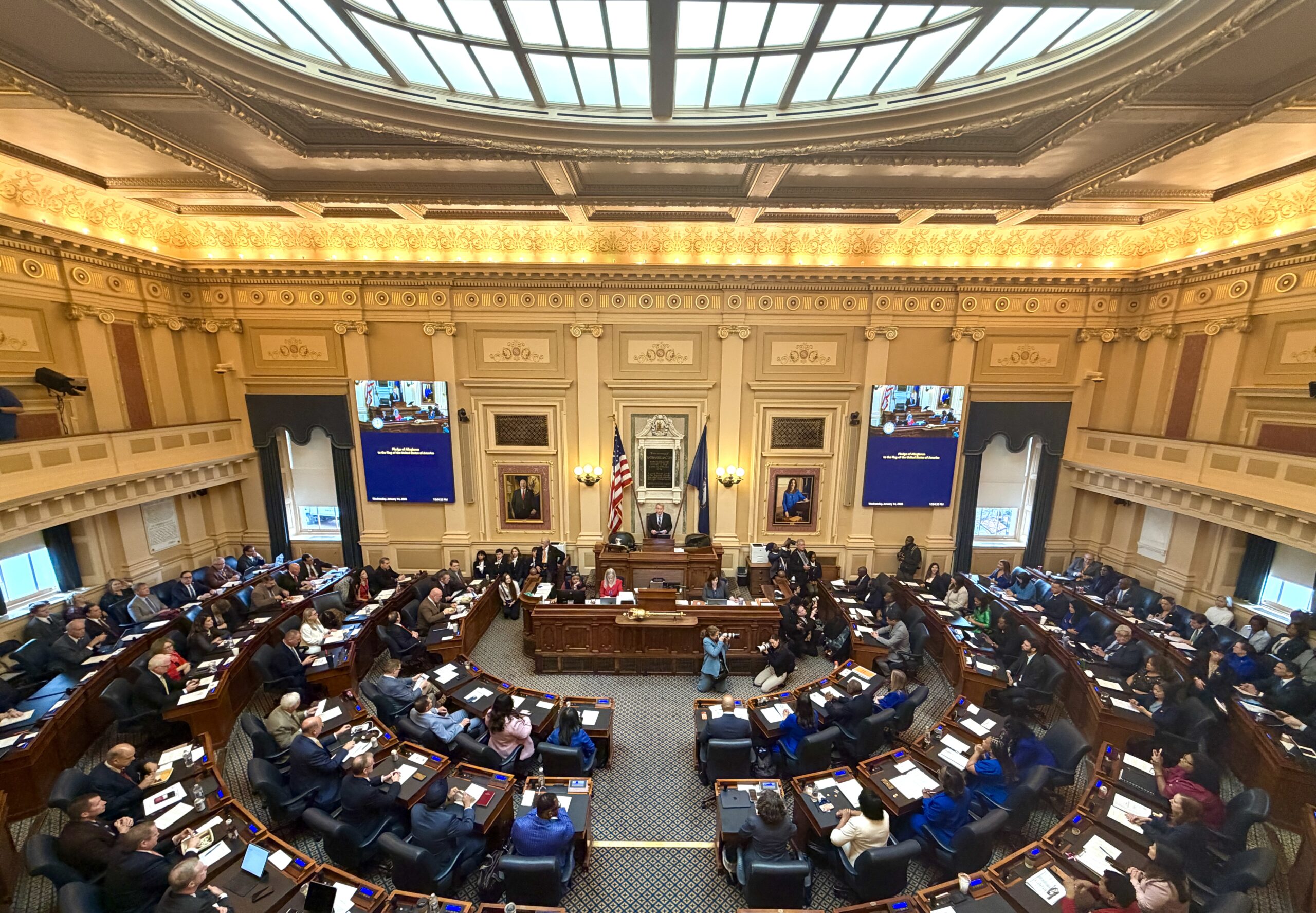 A real-time photograph of the U.S. House chamber during floor debate with members seated and a speaker at the rostrum, news photography style