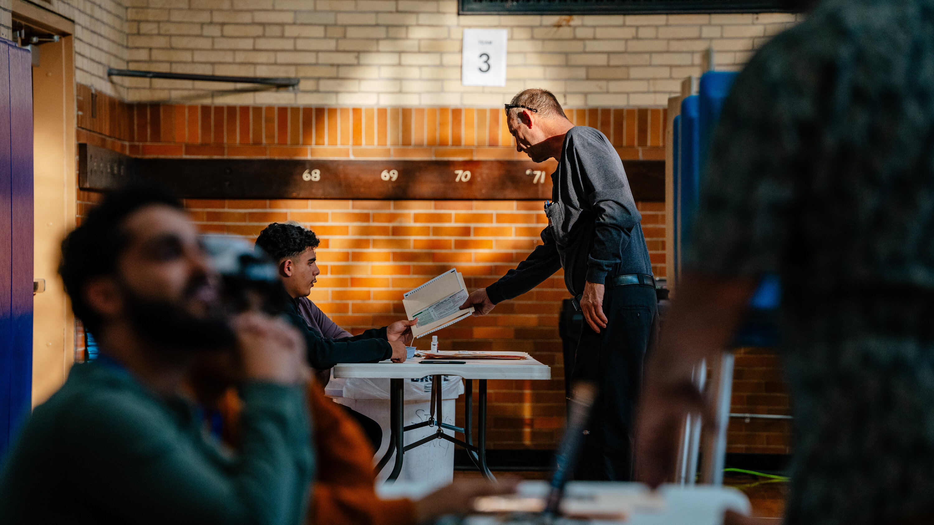 A secured election records storage room in Wayne County, Michigan, with sealed ballot containers stacked on shelving, documentary news photograph style