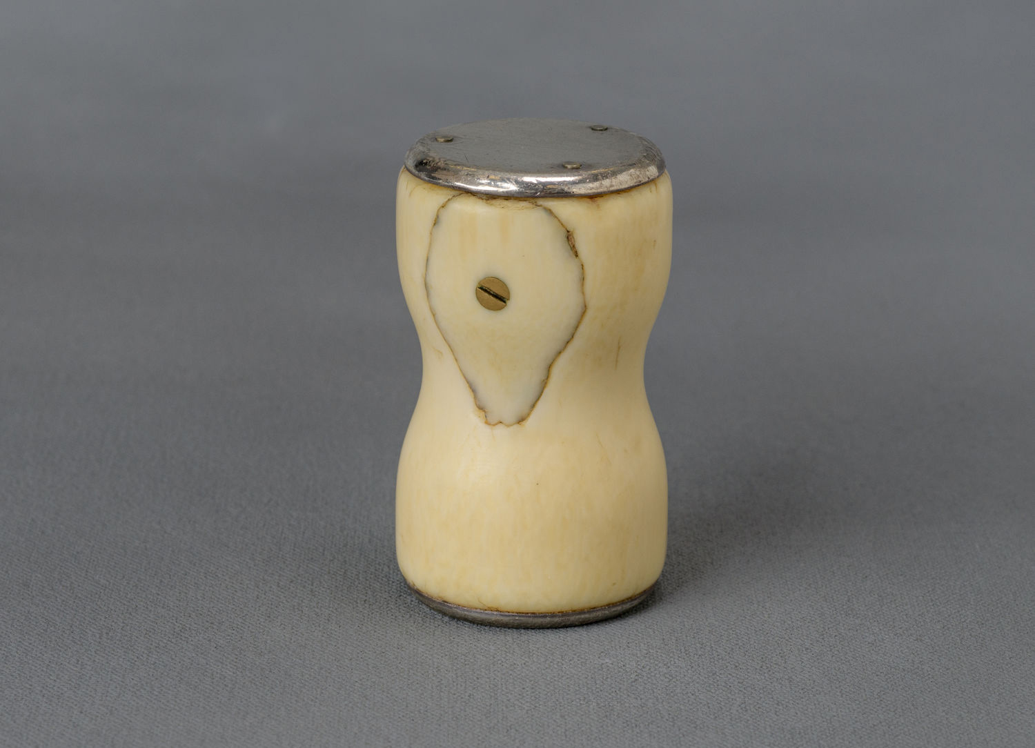 A senator holding a wooden gavel at the Senate rostrum with papers and microphones visible, photographed in a realistic legislative setting