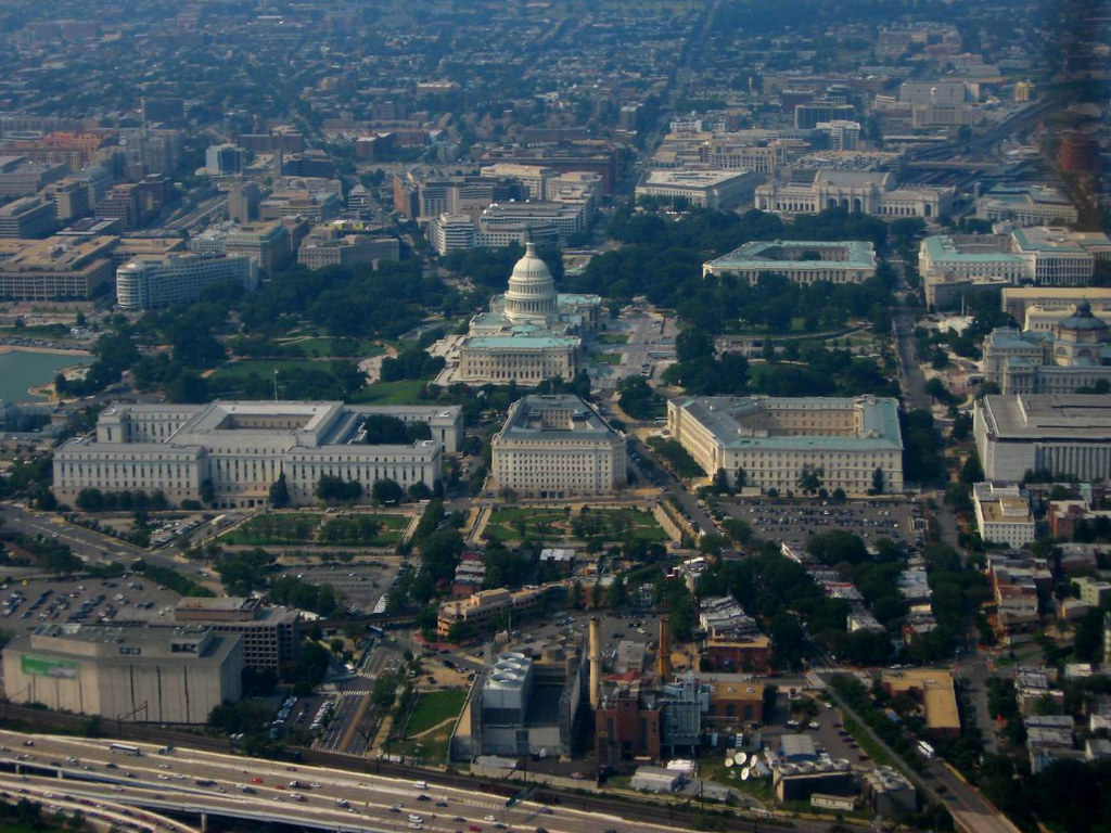 A wide-angle photograph of the U.S. House of Representatives chamber showing the rostrum and seating areas, with no broadcast graphics or on-screen banners