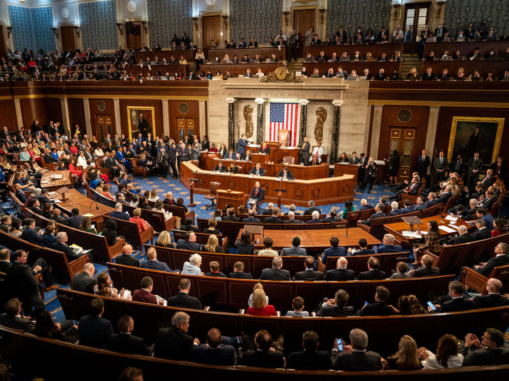 A wide-angle photograph of the United States House of Representatives chamber during a session, with members seated and the Speaker's dais visible