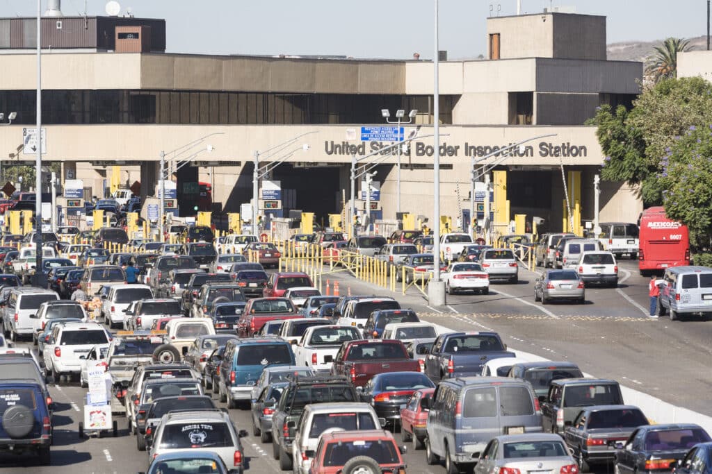 A wide exterior view of a U.S. Customs and Border Protection port of entry facility in El Paso, Texas, showing inspection lanes and CBP signage