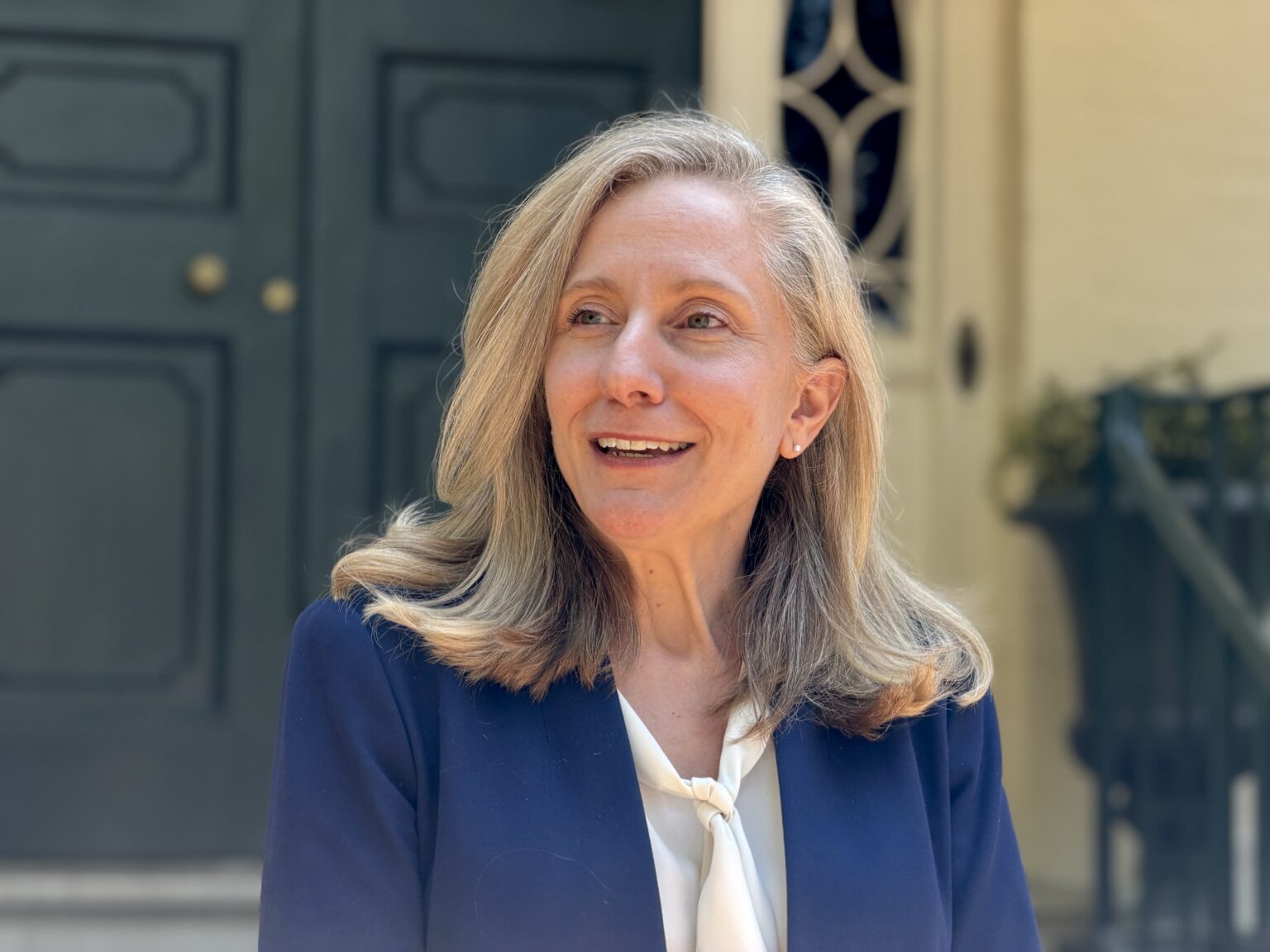 Abigail Spanberger speaking at a crowded indoor campaign event in Virginia during the April 2026 referendum push, news photography style