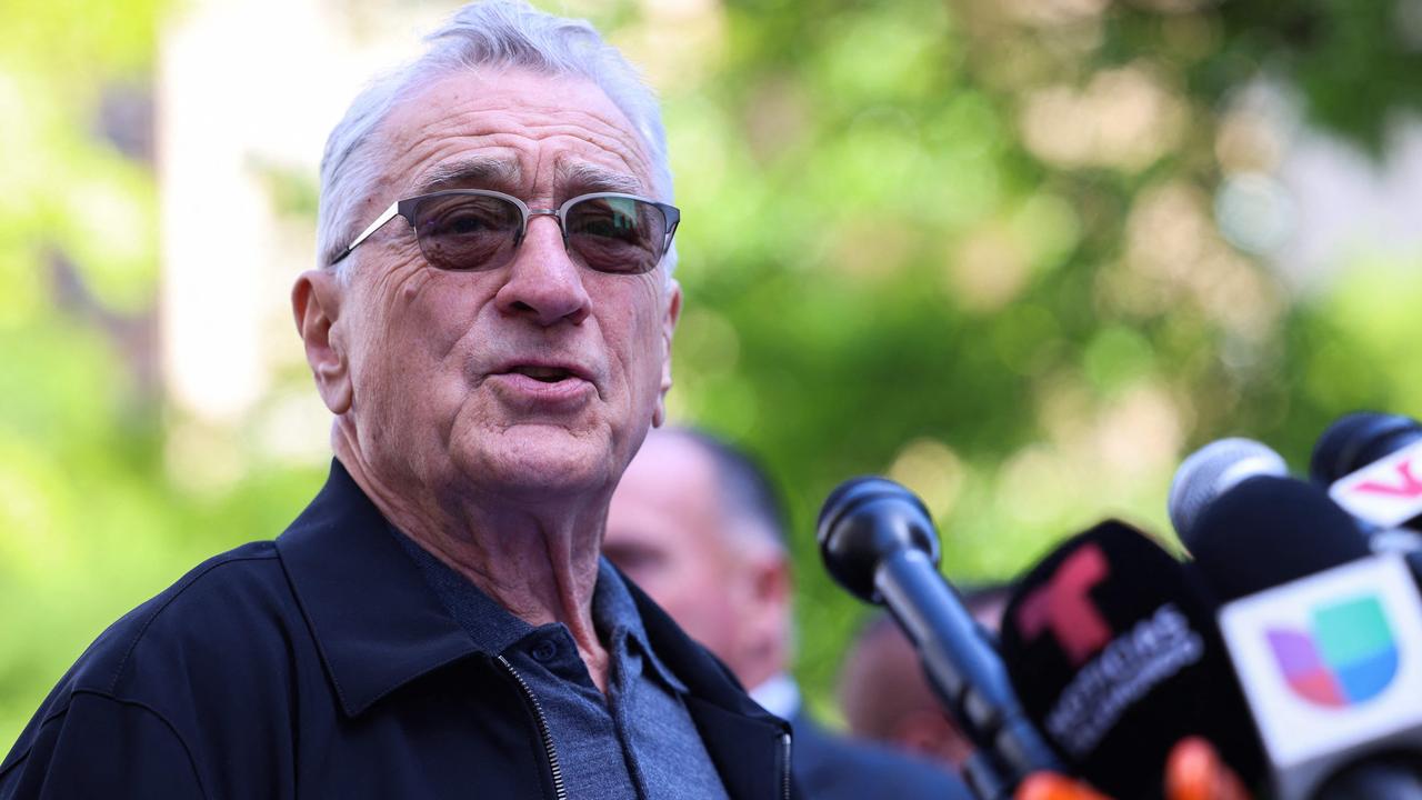 Actor Robert De Niro speaking publicly into a microphone during an appearance
