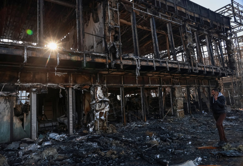 Aftermath scene in the Kyiv region showing emergency response to a strike site, with visible damage consistent with a real news photograph