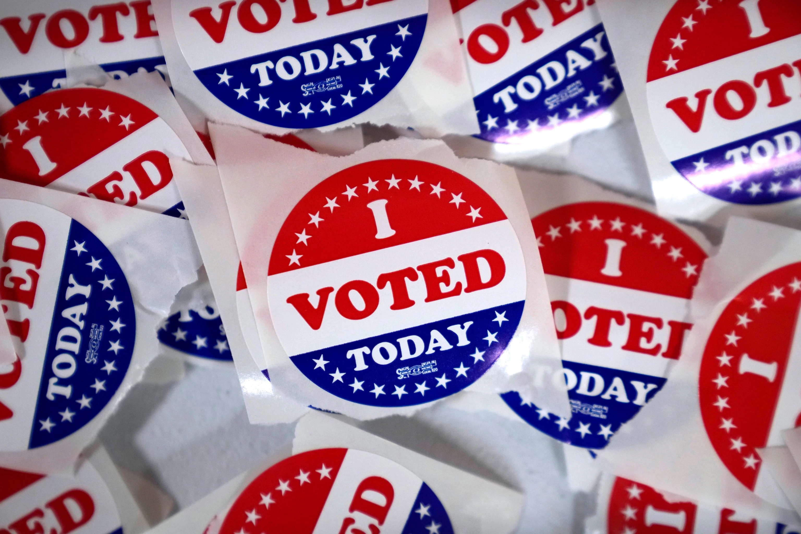 An American polling place sign and an 'I Voted' sticker, illustrating Election Day voting