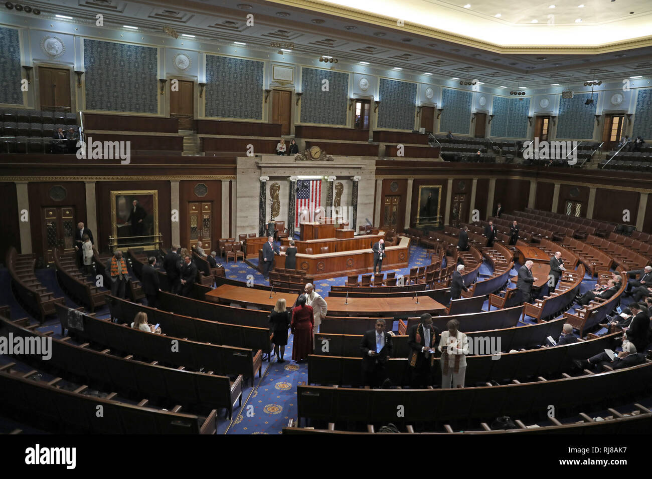 An empty legislative chamber in the United States Capitol with desks and seats visible, quiet and unoccupied, news photography style