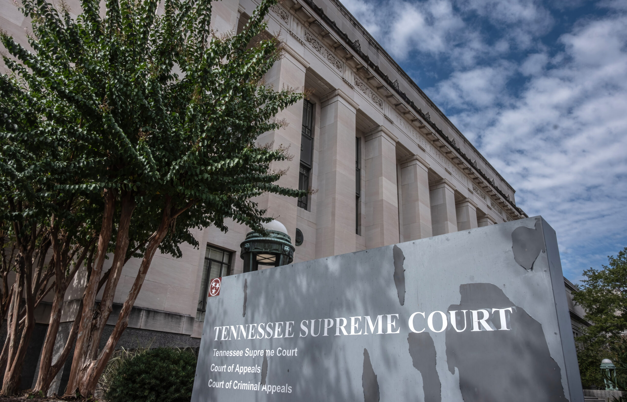 Attorneys presenting oral arguments in a state supreme court courtroom during a redistricting case, judges seated on the bench, news photography style