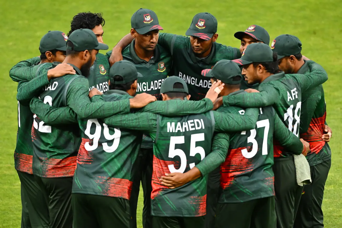 Bangladesh men’s cricket team players in green kits standing together in a pre-match huddle during an international T20 match