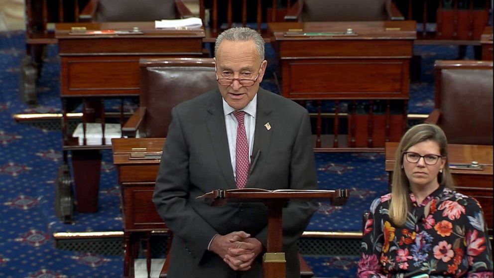 Chuck Schumer speaking on the U.S. Senate floor with senators seated behind him, televised news photography style