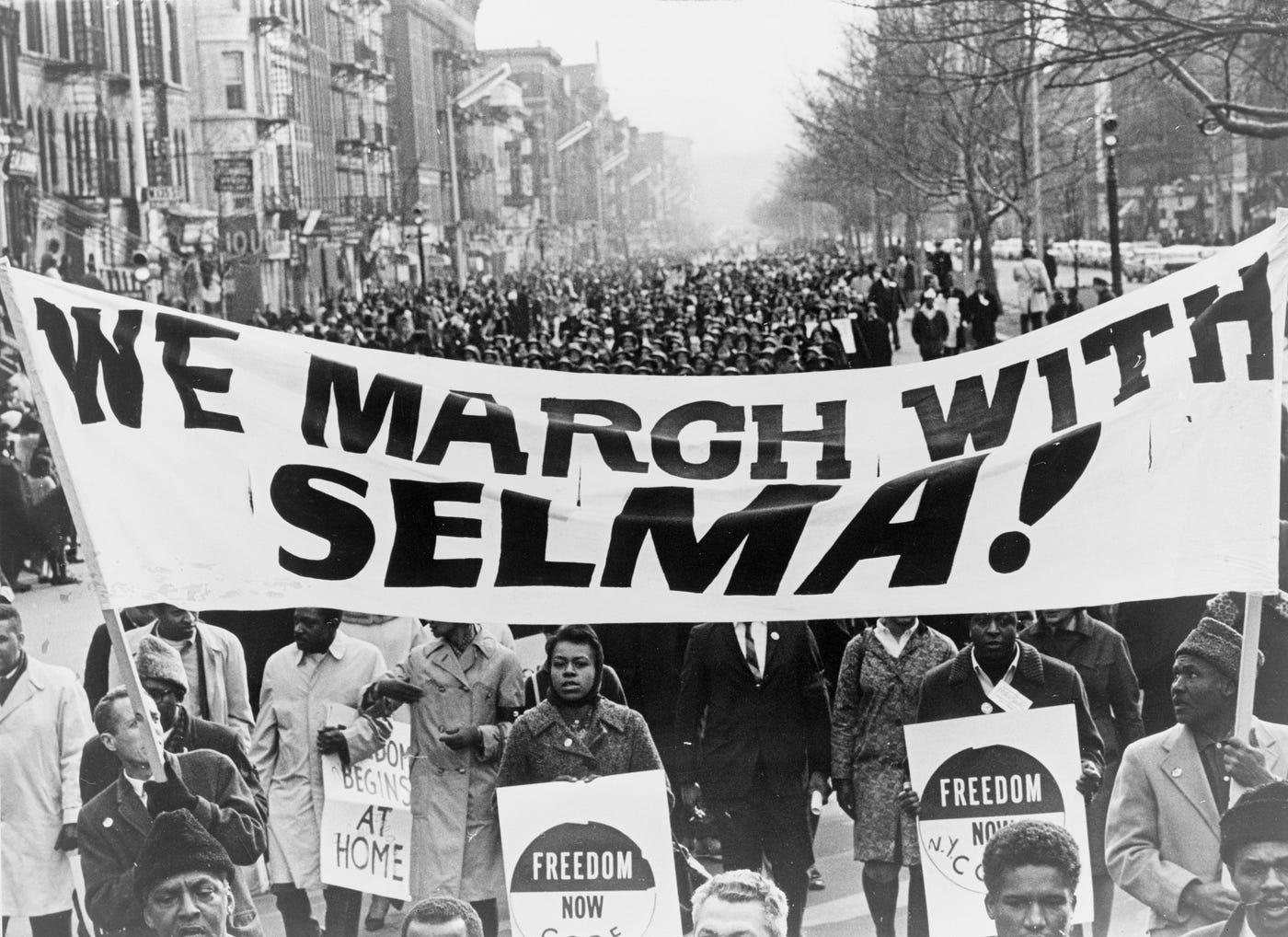 Civil rights marchers walking along an Alabama highway during the Selma to Montgomery voting rights marches, real documentary photograph