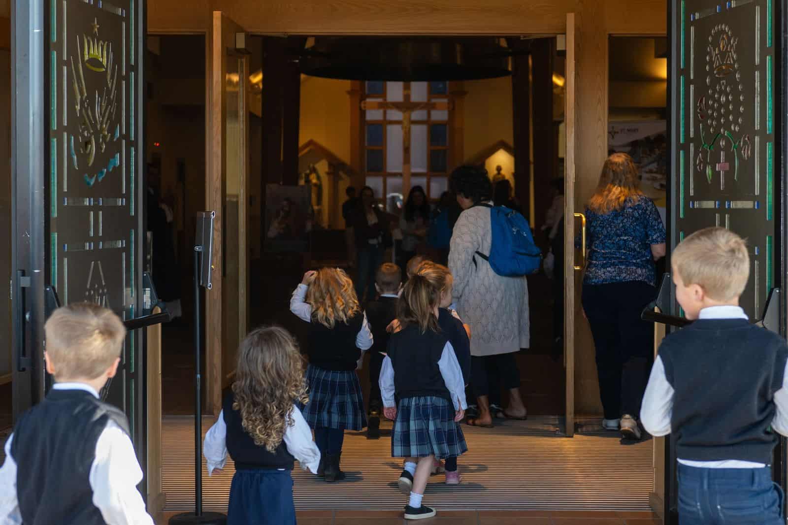 Daniel and Lisa Sheley standing outdoors with their children near a neighborhood sidewalk in Colorado, news photography style