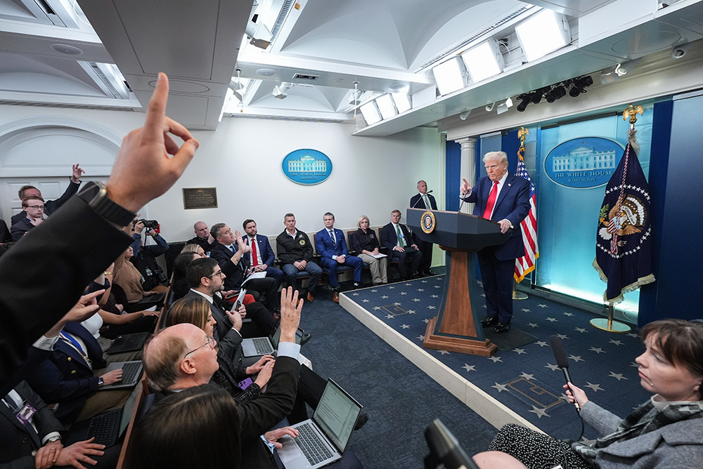 Donald Trump speaking at a White House podium