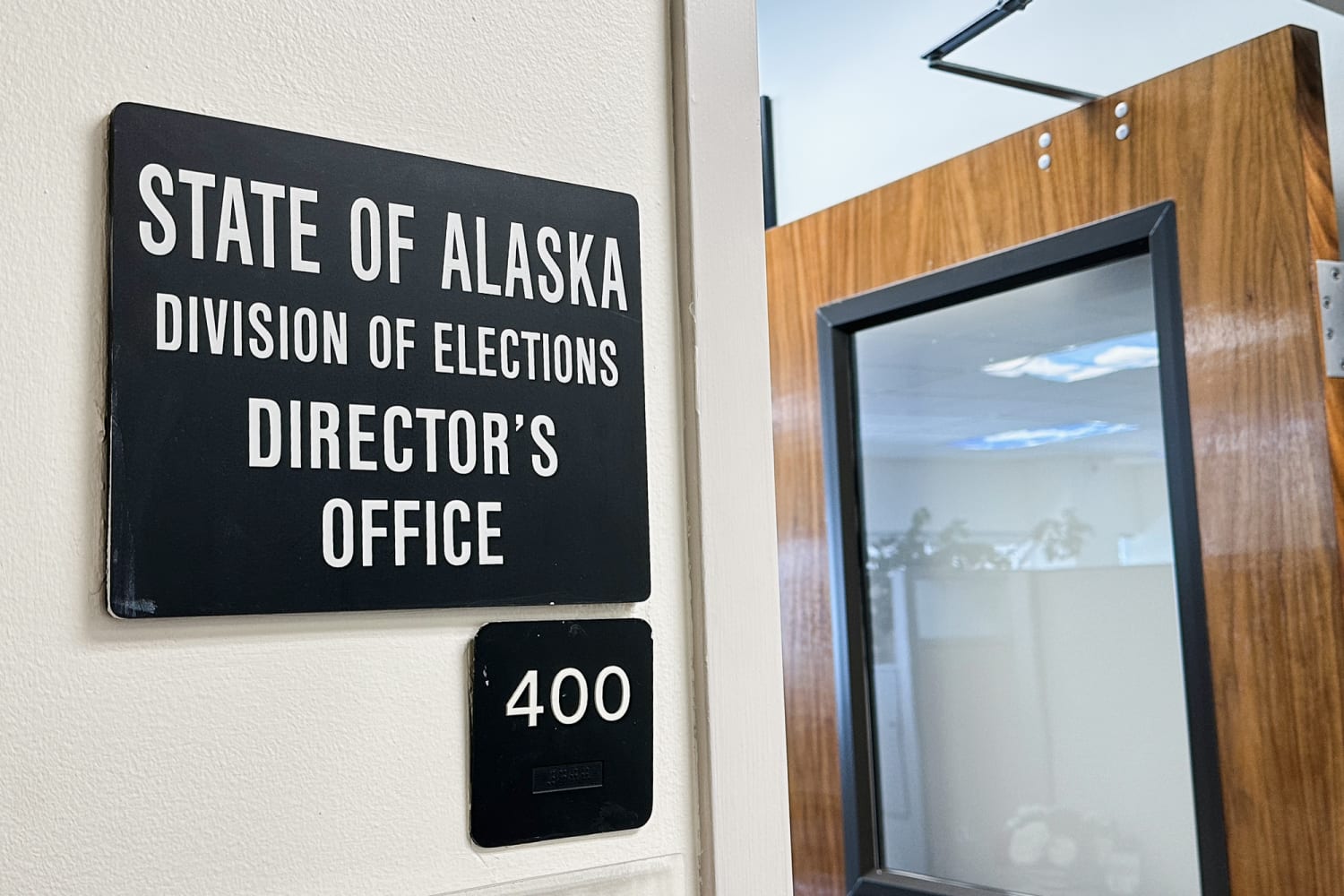 Exterior view of the Alaska Division of Elections office in Anchorage, Alaska, showing official signage and the public entrance.