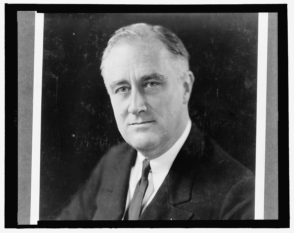 Franklin D. Roosevelt seated at a desk in a historic photograph, representing the era that led to the 22nd Amendment