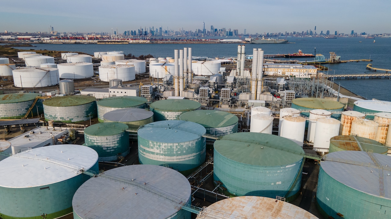 Fuel storage tanks at a waterfront petroleum terminal in the New York Harbor area, part of the regional storage and distribution network that supplies distillate fuels to the Northeast